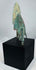 Compact barbed Iranian bronze arrowhead with swallow-wing profile and green patina