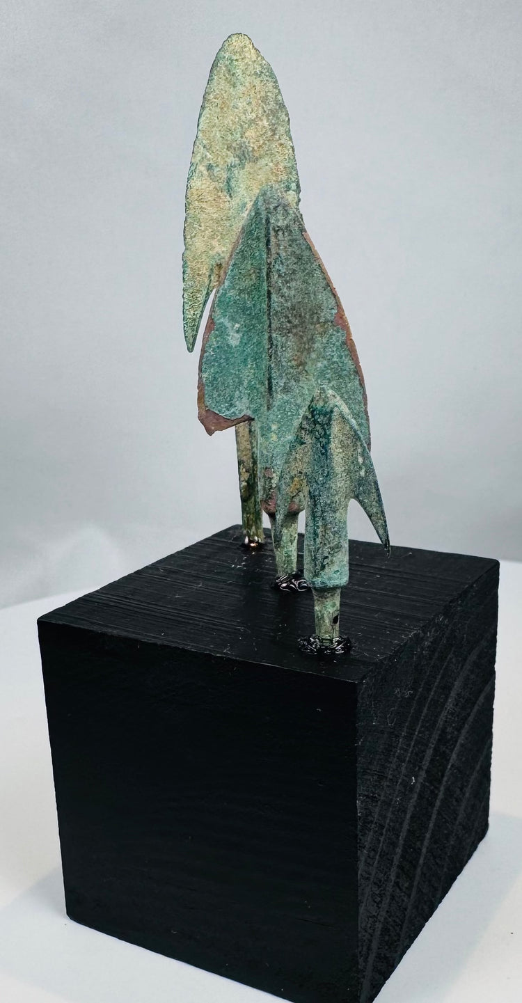 Compact barbed Iranian bronze arrowhead with swallow-wing profile and green patina
