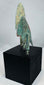 Compact barbed Iranian bronze arrowhead with swallow-wing profile and green patina