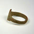 Ancient bronze jewelry with distinctive bezel, worn surface texture, and preserved historic character