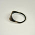 Ancient bronze signet-style ring displaying a horned bull motif on an oval bezel