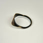 Ancient bronze signet-style ring displaying a horned bull motif on an oval bezel