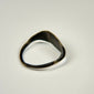 Ancient Mediterranean bronze jewelry with detailed horned bull engraving and historic surface wear