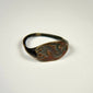 Mediterranean bronze finger ring featuring an engraved bull motif and natural green patina
