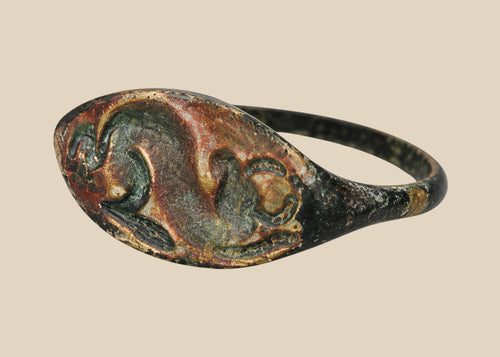 Ancient bronze ring from the Mediterranean or Near East, 1st–4th Century CE, featuring an oval bezel engraved with a horned bull symbolizing strength, power, and fertility. Natural green patina and finely detailed engraving preserve the historical artistry and cultural significance of this antiquity.