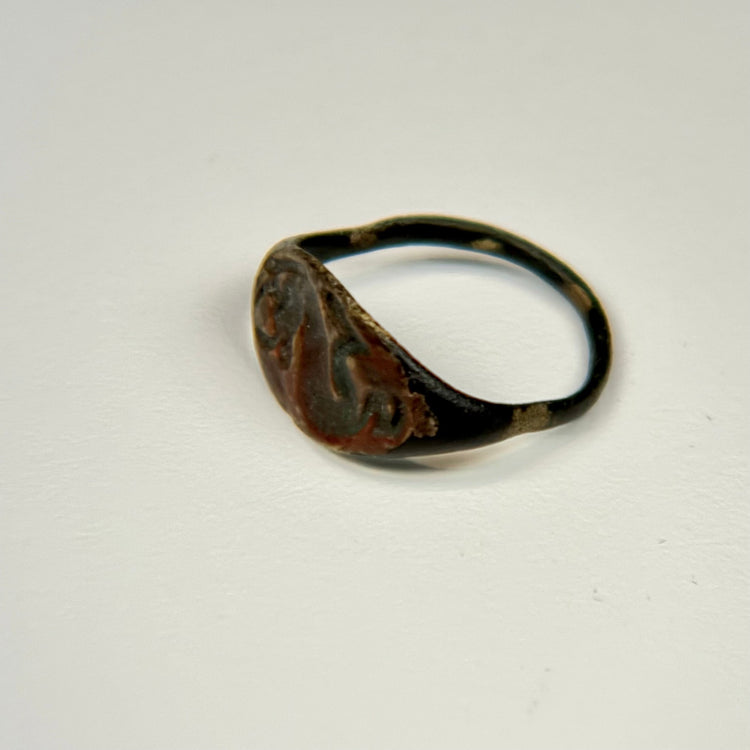 Ancient bronze bull ring with symbolic engraved bezel and naturally developed archaeological patina