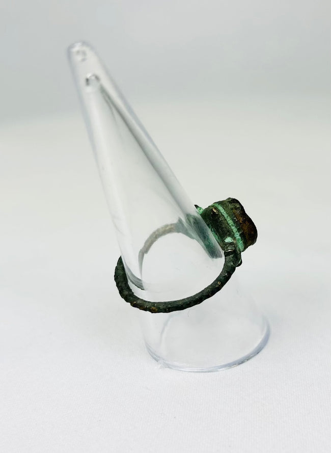 Bronze ring from ancient collection displayed on angled clear stand