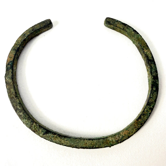 Ancient bronze bangle showing textured green oxidation and age-related surface wear from the 1st to 3rd century AD