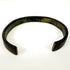 Archaeological iron bracelet with broad open cuff form and naturally weathered dark surface