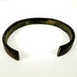 Archaeological iron bracelet with broad open cuff form and naturally weathered dark surface