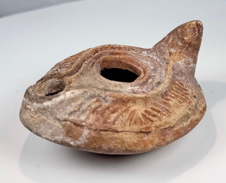 Byzantine terracotta lamp with central filling hole, wick opening, and solid handle