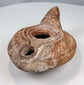 Ancient reddish-brown pottery oil lamp with herringbone-style incised decoration