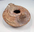 Ancient Mediterranean terracotta lamp with oval body, extended nozzle, and rear handle