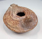Ancient Mediterranean terracotta lamp with oval body, extended nozzle, and rear handle