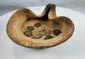 Historic Carthaginian oil lamp featuring folded rim design and group of bronze coins