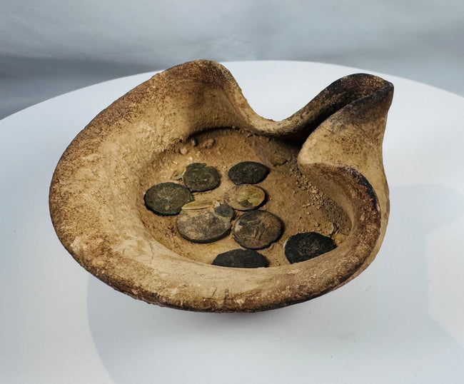 Ancient Mediterranean terracotta oil lamp from Carthage accompanied by bronze coin artifacts