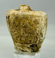 Small carved limestone or calcite flask with mineral deposits and ancient wear