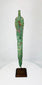 Back of Bronze Age Caspian blade showing drilled perforations and aged patina on custom display stand.
