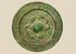 Han Dynasty bronze mirror, circa 206 BCE–220 CE, with engraved geometric and mythical motifs, central suspension knob, and rich green patina.
