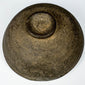 Underside of an ancient Chinese gray pottery bowl showing the circular foot, unglazed earthenware surface, and historic wear.