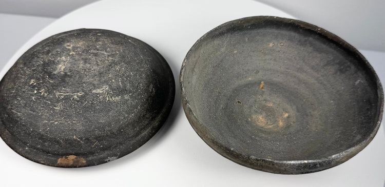 Ancient Chinese gray pottery covered bowl displayed open with lid and lower vessel side by side, showing the fitted two-part construction.