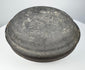 Ancient Chinese gray pottery covered box viewed from above, highlighting the broad domed cover and dark aged surface.