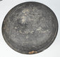 Exterior of an ancient Chinese Tang Dynasty pottery lid with charcoal-gray surface, wear, deposits, and concentric forming marks.