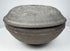 Ancient Chinese Tang Dynasty covered pottery bowl shown in profile with projecting meeting rims and shallow domed cover.