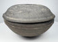 Ancient Chinese Tang Dynasty covered pottery bowl shown in profile with projecting meeting rims and shallow domed cover.