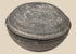 Ancient Chinese gray pottery covered bowl attributed to the Tang Dynasty, shown closed with shallow domed lid and aged earthenware surface.