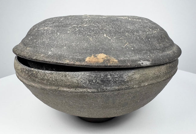 Ancient Tang Dynasty Chinese pottery covered bowl from an alternate angle, showing the lenticular profile and closely fitted two-part form.