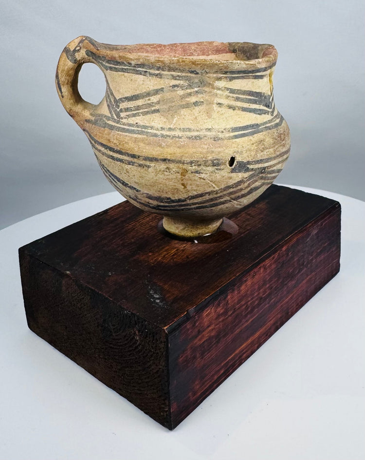 Chinese Neolithic pottery vessel with ring foot and painted triangular motifs