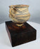 Ancient Chinese ceramic vessel featuring black geometric decoration and red pigment traces