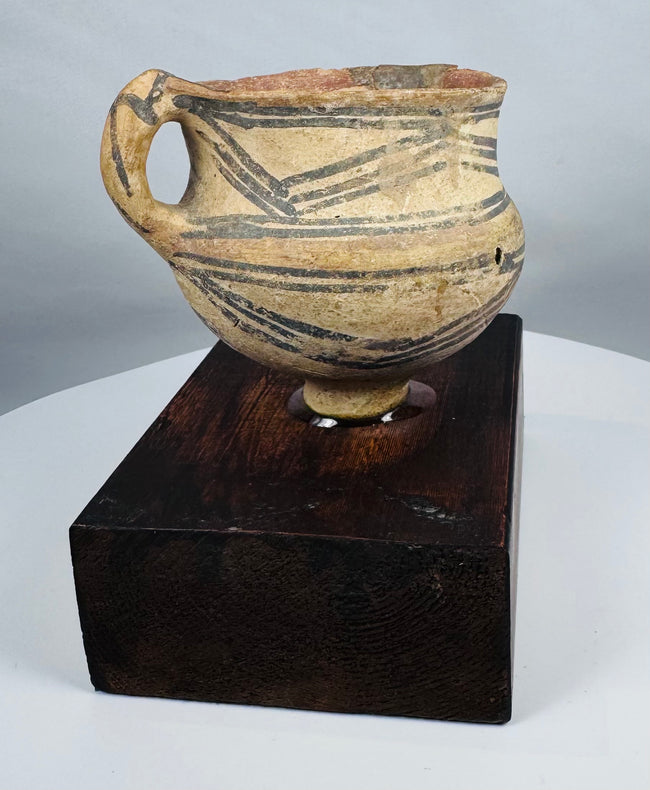 Ancient terracotta vessel from Northwest China mounted on a hardwood display stand