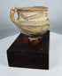 Ancient terracotta vessel from Northwest China mounted on a hardwood display stand