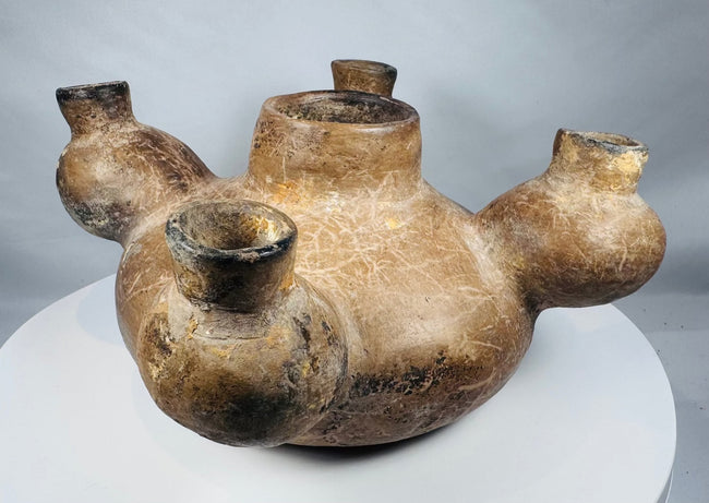 Underside of an ancient Colima vessel showing cracks and mineral deposits