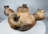 Underside of an ancient Colima vessel showing cracks and mineral deposits