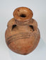 Close-up of black painted decoration on an orange-red Cypriot ceramic surface