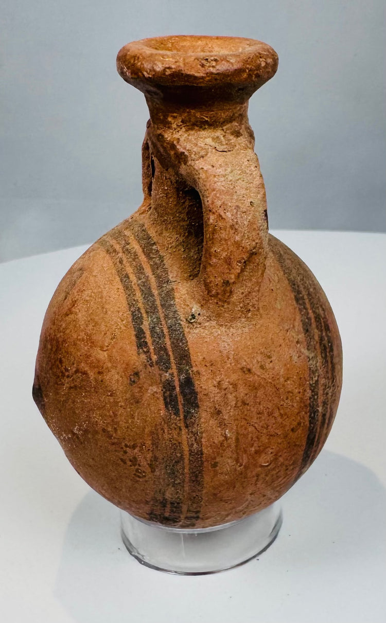 Side view of ancient Cyprus pottery vessel showing rounded body and flattened base