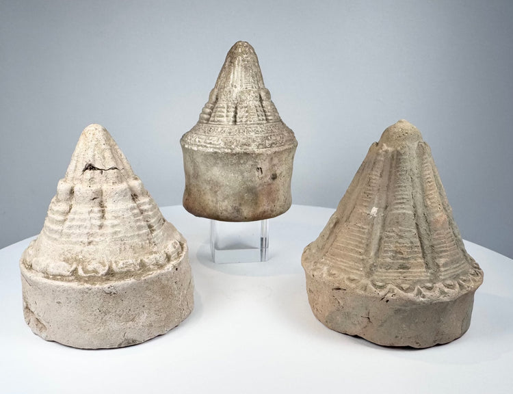 Buddhist clay stupas from Eastern India featuring conical spires, stepped tiers, and circular bases