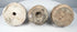 Bottom view of three Eastern Indian Buddhist terracotta votive stupas showing base cavities and impressed features