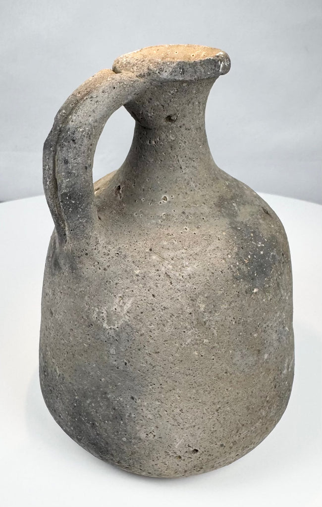 Coarse clay Iron Age vessel with undecorated surface and rounded base