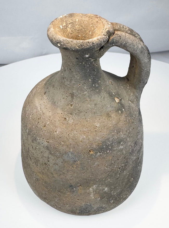 Iron Age ceramic jug with ovoid body and broad handle joining neck to shoulder