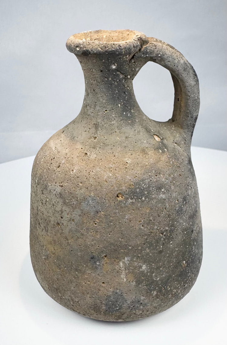 Ancient Levantine single-handled vessel in coarse grey-fired clay