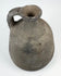 Ancient utilitarian pottery vessel with mineral inclusions and firing irregularities