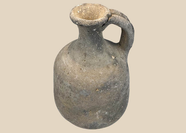 Ancient Iron Age grey earthenware jug with rounded body and loop handle