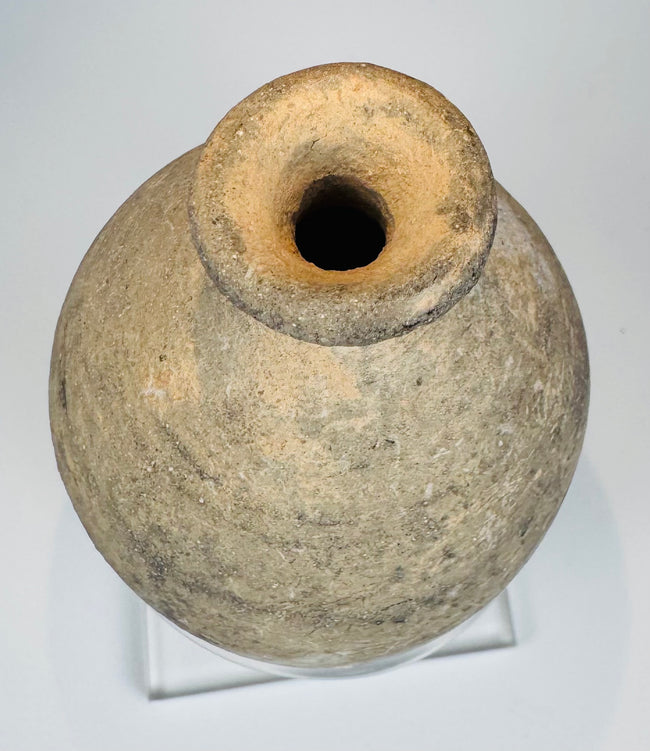 Small Roman Byzantine pottery bottle displayed on a clear acrylic stand