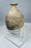 Side view of ancient ceramic flask showing ovoid profile and wheel-turning lines