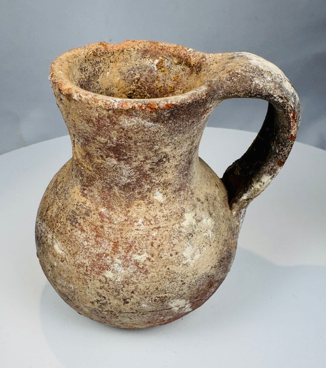Eastern Mediterranean pottery pitcher with tall neck, pinched spout, and burial deposits