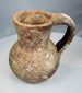 Eastern Mediterranean pottery pitcher with tall neck, pinched spout, and burial deposits